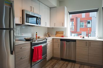 a kitchen with stainless steel appliances and a window at Wilcox, Seattle, Washington, 98107